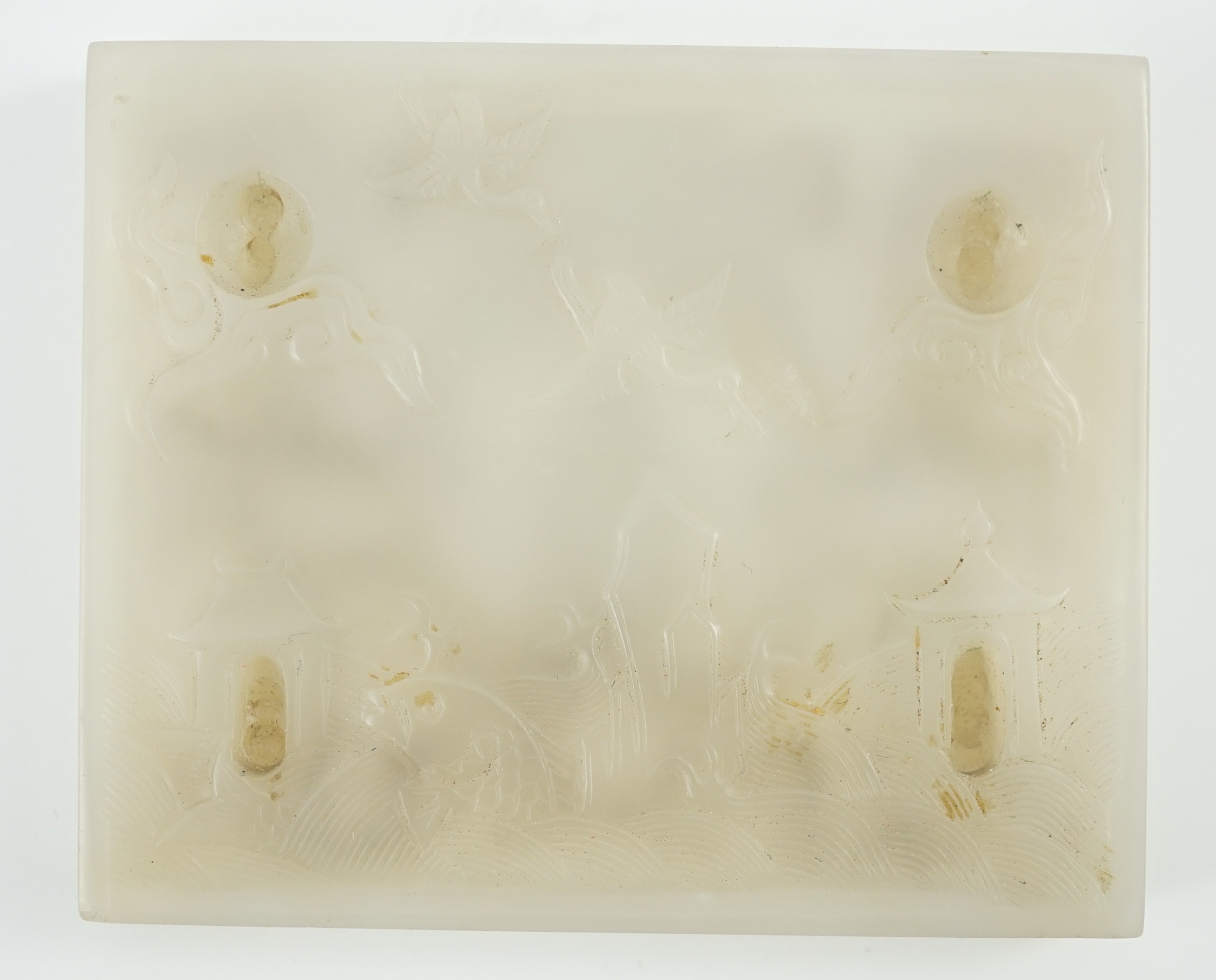 An unusual Chinese white jade plaque, 18th/19th century, 6.7cm x 8.1cm, wood stand
